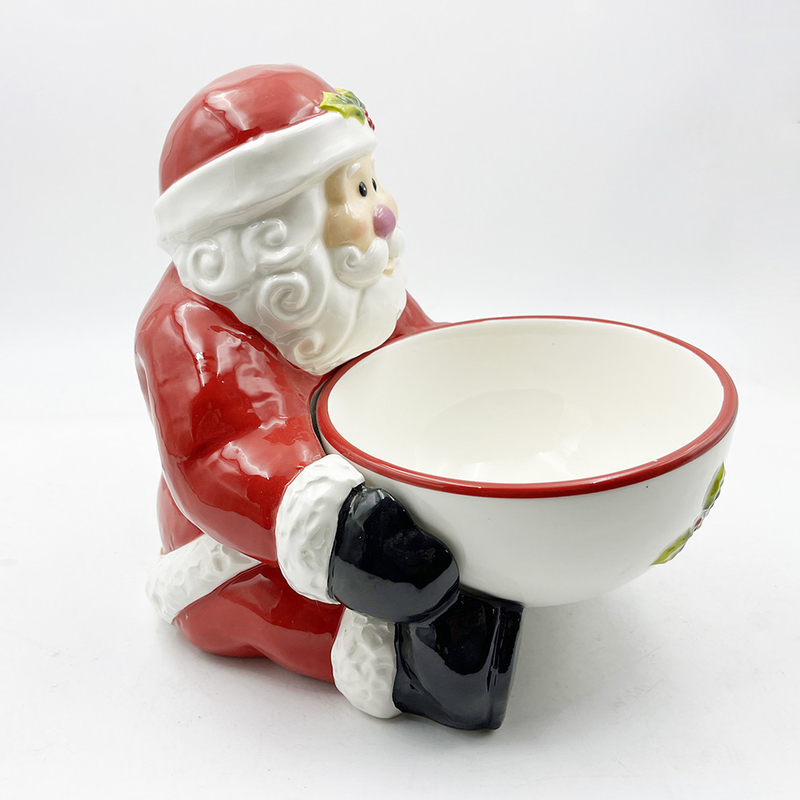 Cucine di ceramica con ciotole di caramelle dipinte a mano con la maniglia di Babbo Natale
